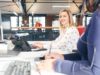 Two persons sitting at their desk