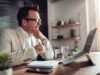 A man sitting infront of a laptop