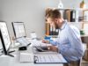 A man sitting at a desk calculating something