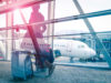 A passenger walking through a gate, waiting for the boarding