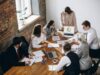 group of finance people working together around a table