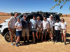 Group of people in front of a Land Rover during Fam Trip in Namibia