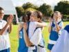 Happy Football Players Hugging On Field After Scoring A Goal.